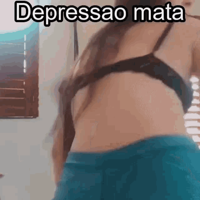 a woman in a bra and shorts is dancing in front of a mirror .