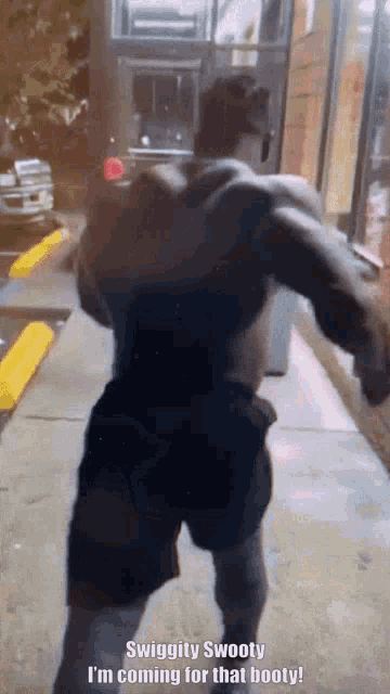 a man is standing on a sidewalk with the words swiggity swooty i 'm coming for that booty