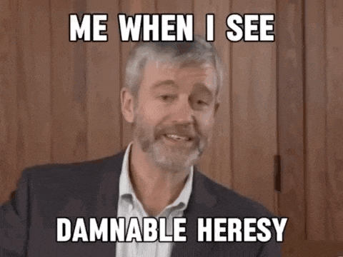 a man in a suit and tie is making a funny face and says `` me when i see damnable heresy ''