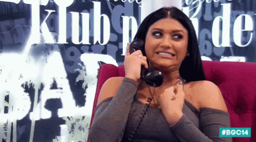 a woman talking on a phone with the word klub behind her