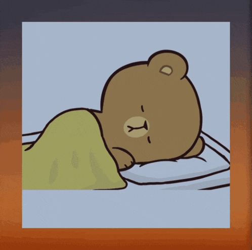 a brown teddy bear is sleeping on a bed