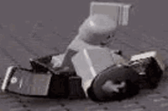 a lego man is sitting in a chair on a gray surface .