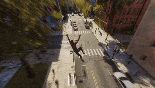 an aerial view of a spider-man jumping over a street