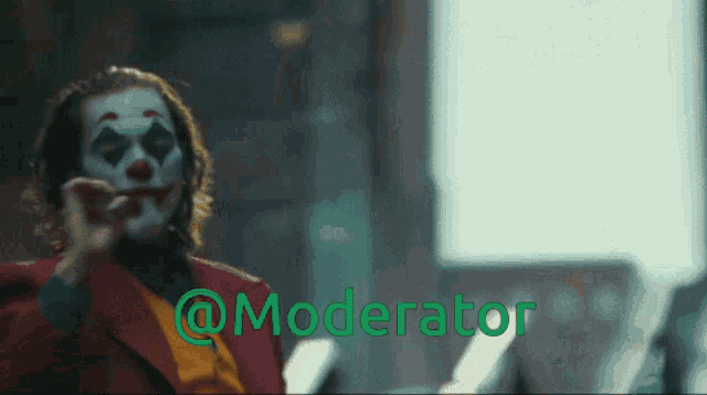 a man in a clown costume with the words @moderator behind him