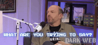 a man sitting in front of a microphone with the words " what are you trying to say " on the screen