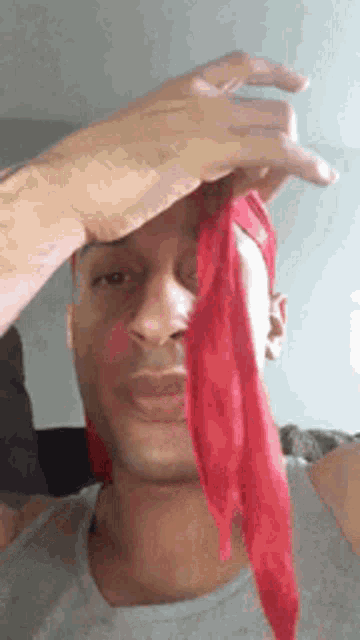 a man wearing a red scarf around his head