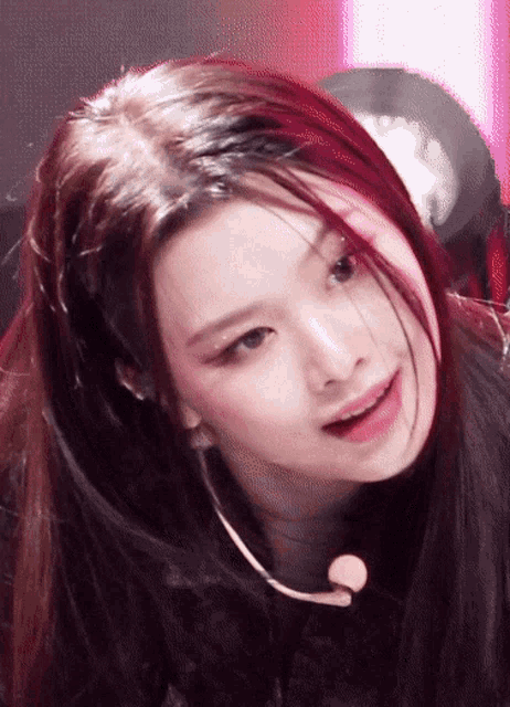 a close up of a woman 's face with a microphone in her hair
