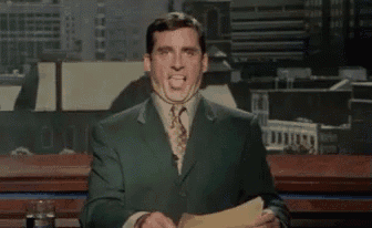 a man in a suit and tie is holding a piece of paper and making a face