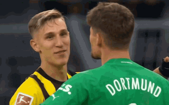 a man in a green jersey with the name dortmund on it