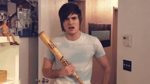 a man is holding a baseball bat that says louisville