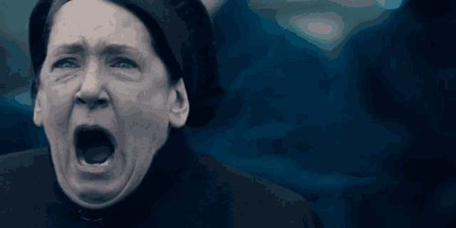 a close up of a woman with her mouth open .