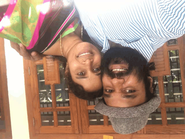 a man and a woman are posing for a picture upside down