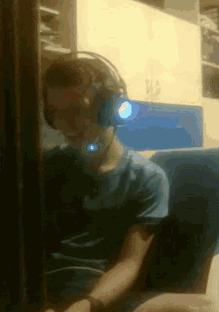 a blurry picture of a man wearing headphones and a headset