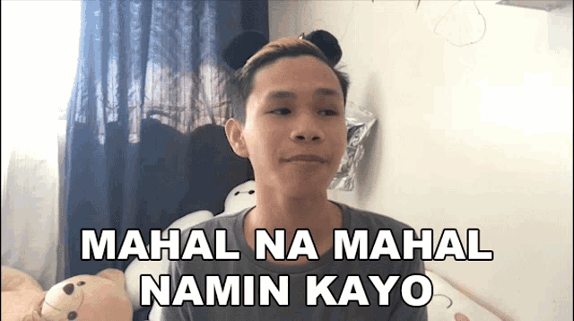 a man wearing a headband with teddy bear ears and the words mahal na mahal namin kayo