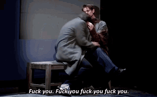 two men are sitting on a stool and one of them is saying " fuck you "
