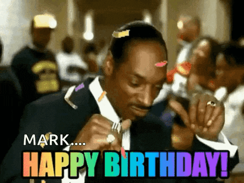 a man in a suit is saying happy birthday to mark