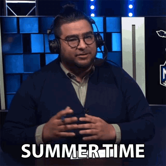 a man wearing a headset and glasses says summertime