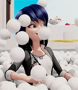 a cartoon character is sitting in a pile of white balls .