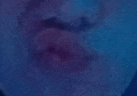 a close up of a person 's face with a blue and purple background