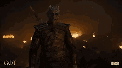 a man with horns is holding a sword in front of a fire and the word got is on the bottom