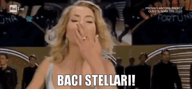a woman blowing a kiss with the words " baci stellari " on the bottom