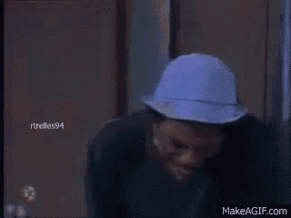 a man in a blue hat is sitting on a couch