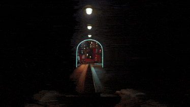 a person riding a roller coaster in a tunnel with cartoon characters in the background