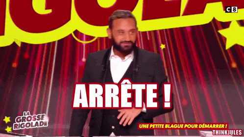 a man in a suit is standing in front of a sign that says arrete !