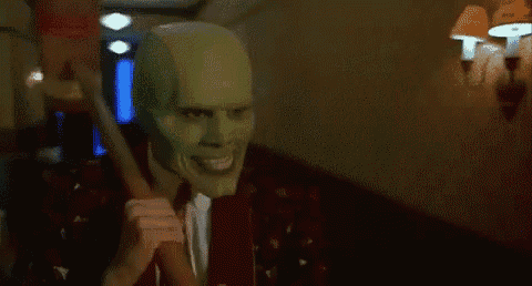 a man in a suit and tie is wearing a mask with googly eyes