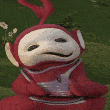 a red and white teletubbies character is holding something in his hand
