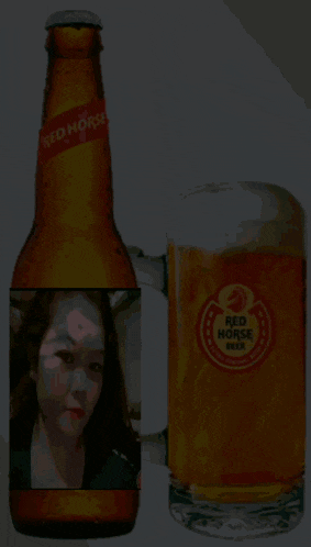 a bottle of red horse beer sits next to a full glass