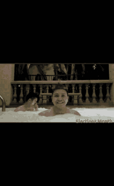 a man is taking a bath in a jacuzzi with the words elections month written on the bottom