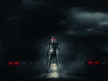 a man in a black suit with red eyes is standing in the dark