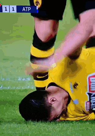 a soccer player is laying on the ground with the number 11 at the bottom