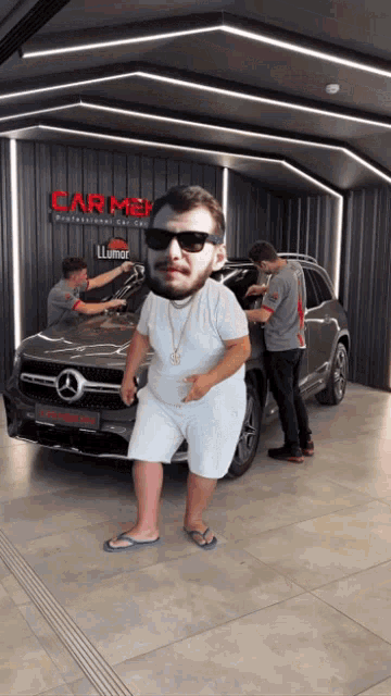 a man in sunglasses is standing in front of a car that says carmer on it