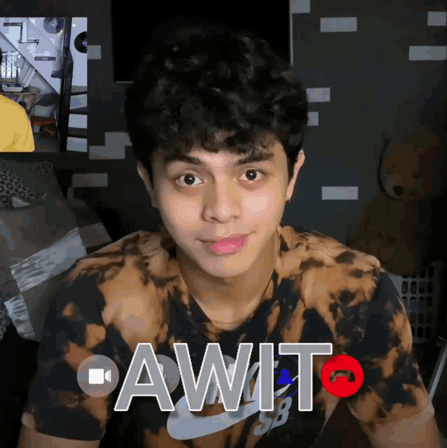 a young man wearing a nike shirt with the word awt on the front