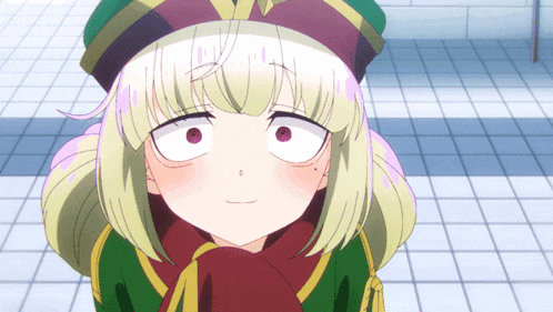 a close up of a girl 's face with a green hat and a red scarf