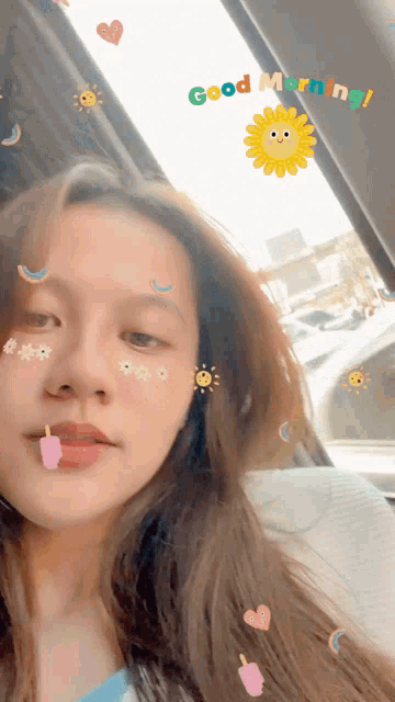 a woman in a car with stickers on her face and the words good morning