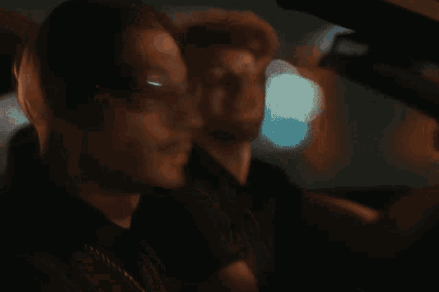 a man and a woman are sitting in a dark room