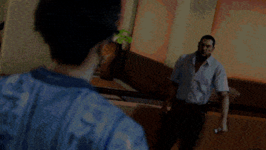 a man wearing a blue shirt with the word jesus on it