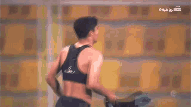 a man wearing a catapult sports bra is running