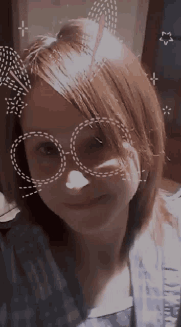 a young girl wearing glasses and a unicorn horn