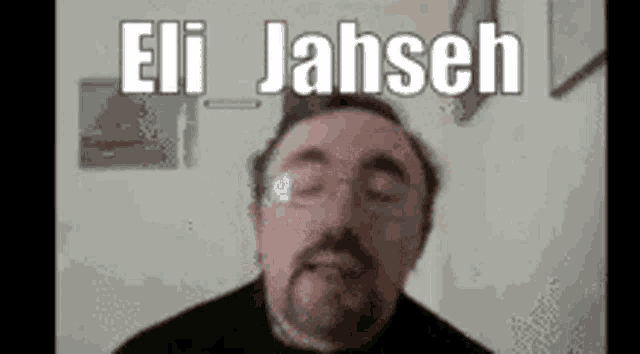 a man with glasses and a beard is making a funny face with the words eli jahseh written on it .