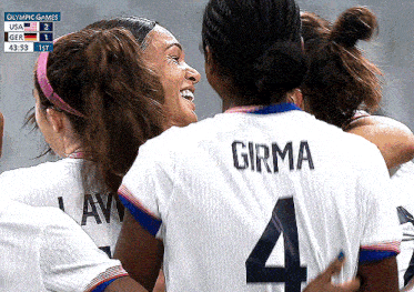 a group of female soccer players are huddled together and one of them is wearing a number 4 jersey