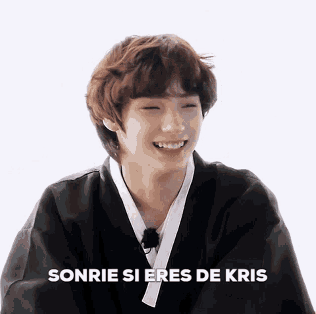 a young man in a kimono is smiling and the words sonrie si eres de kris are above him