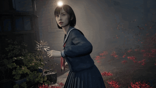 a girl in a school uniform is standing in a dark area with red flowers