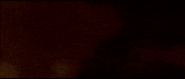 a blurred image of a flower with a dark background