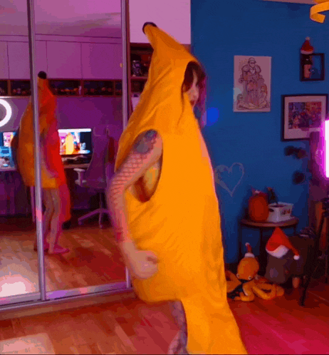 a man in a yellow banana costume is dancing in a room