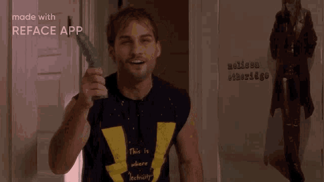 a man wearing a shirt that says this is where electricity comes is smiling