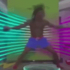 a woman in blue shorts is standing in front of a wall with neon lights .